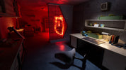 Dark room with a desk, chair, and red lighting