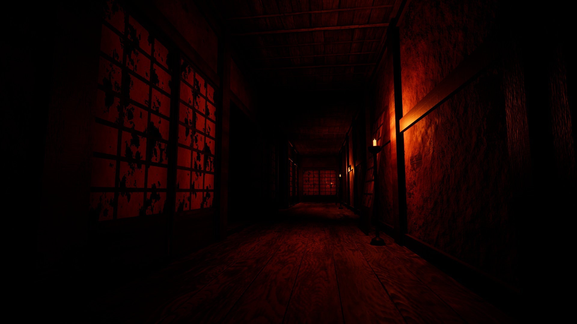 Dark, narrow hallway with red lighting and barred doors.