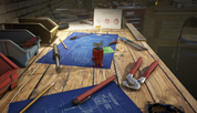 Workbench with tools and blueprints on a wooden surface