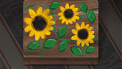 Wooden puzzle with sunflower designs on a dark background