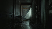 Dark, eerie hallway with a draped sheet hanging from an open door