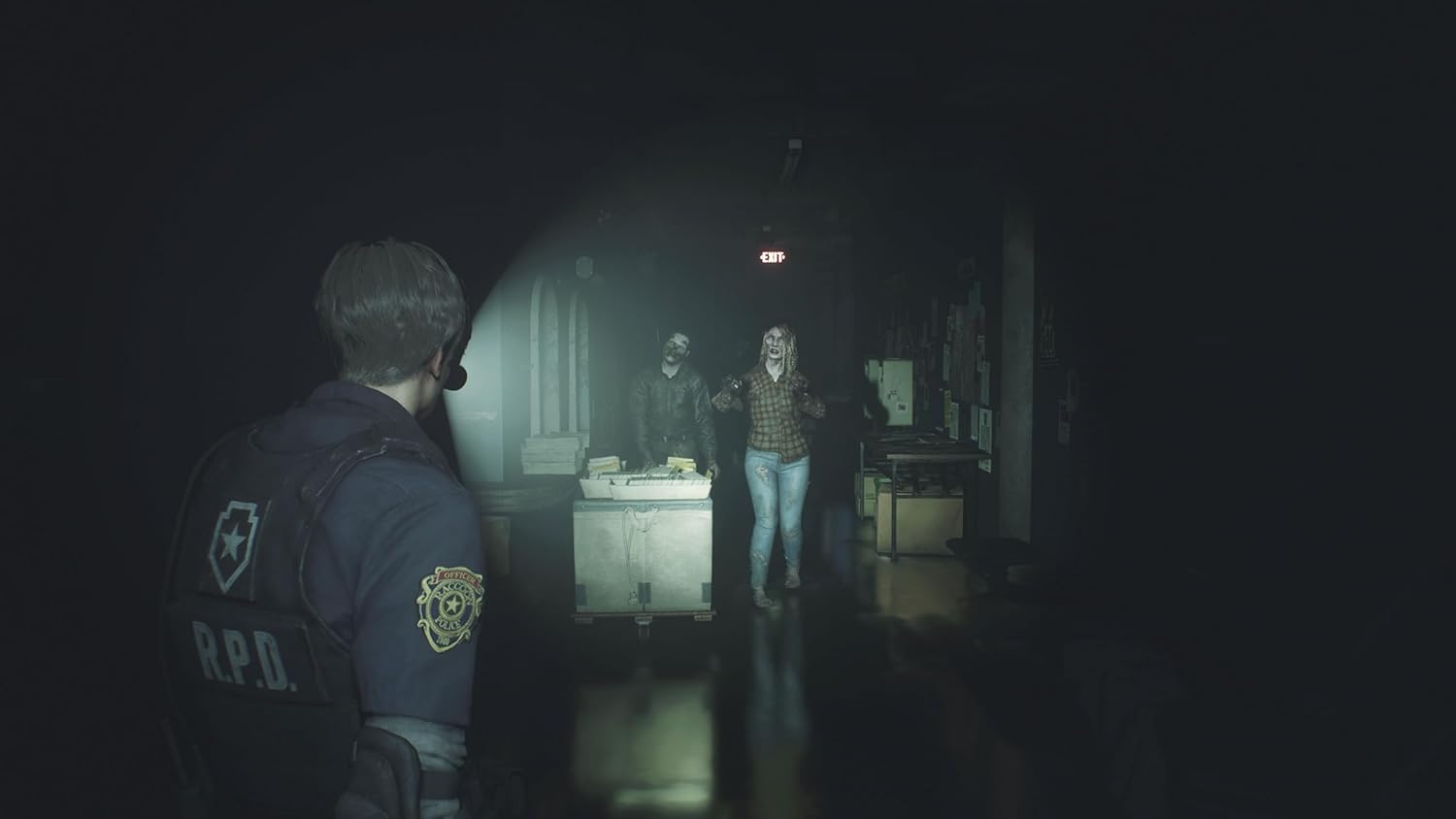 Person in RPD uniform facing two other people in a dimly lit room