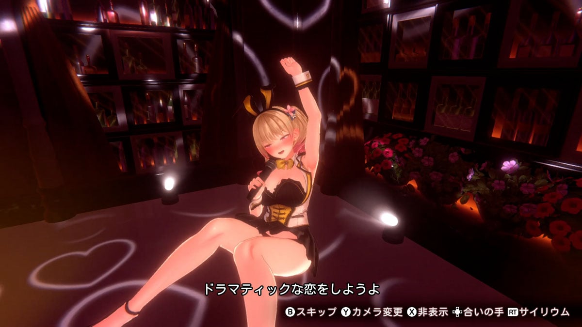 An anime-style digital scene showing a blonde female character in a black and gold outfit posing on a dark stage with projected heart shapes, shelves of bottles, and flowers in the background.