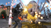 A video game scene showing a soldier in dark tactical gear firing at a giant spider-like creature in an outdoor urban environment, with sparks and glowing effects visible.