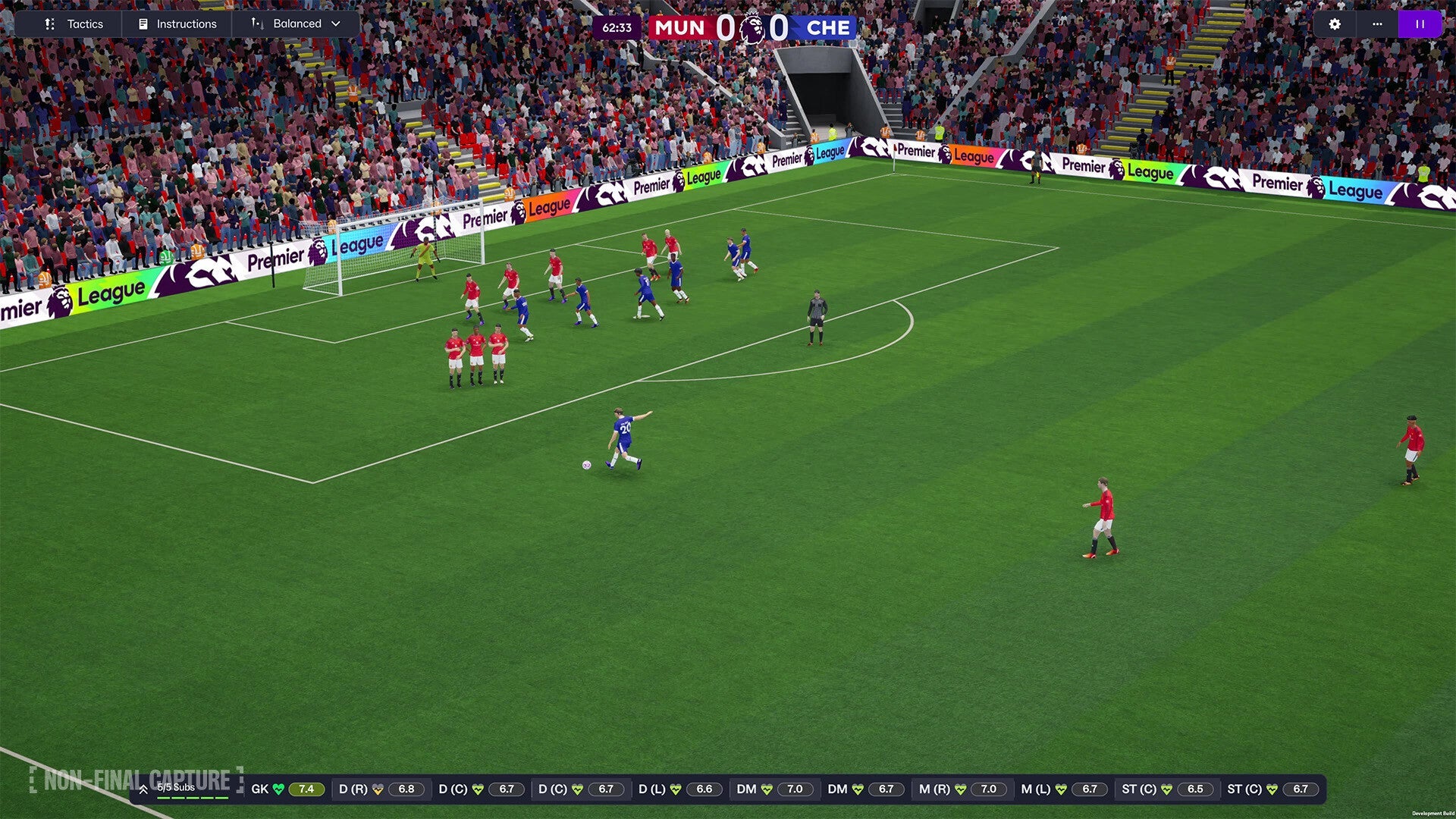 Soccer match in progress with players on a field, surrounded by spectators and advertisements.