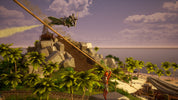 Person standing on a sand dune with a helicopter in the sky, surrounded by palm trees and ocean.