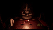 A dark, atmospheric scene featuring a seated Ganesha statue on a wooden table, surrounded by small red clay lamps, a white shell, and incense sticks in a very dim, moody setting.