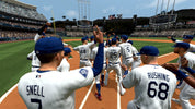 Baseball players on a field with stadium in the background