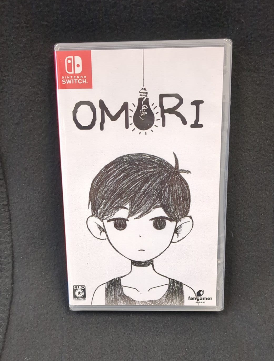 Nintendo Switch game case for 'Omori' on a dark background