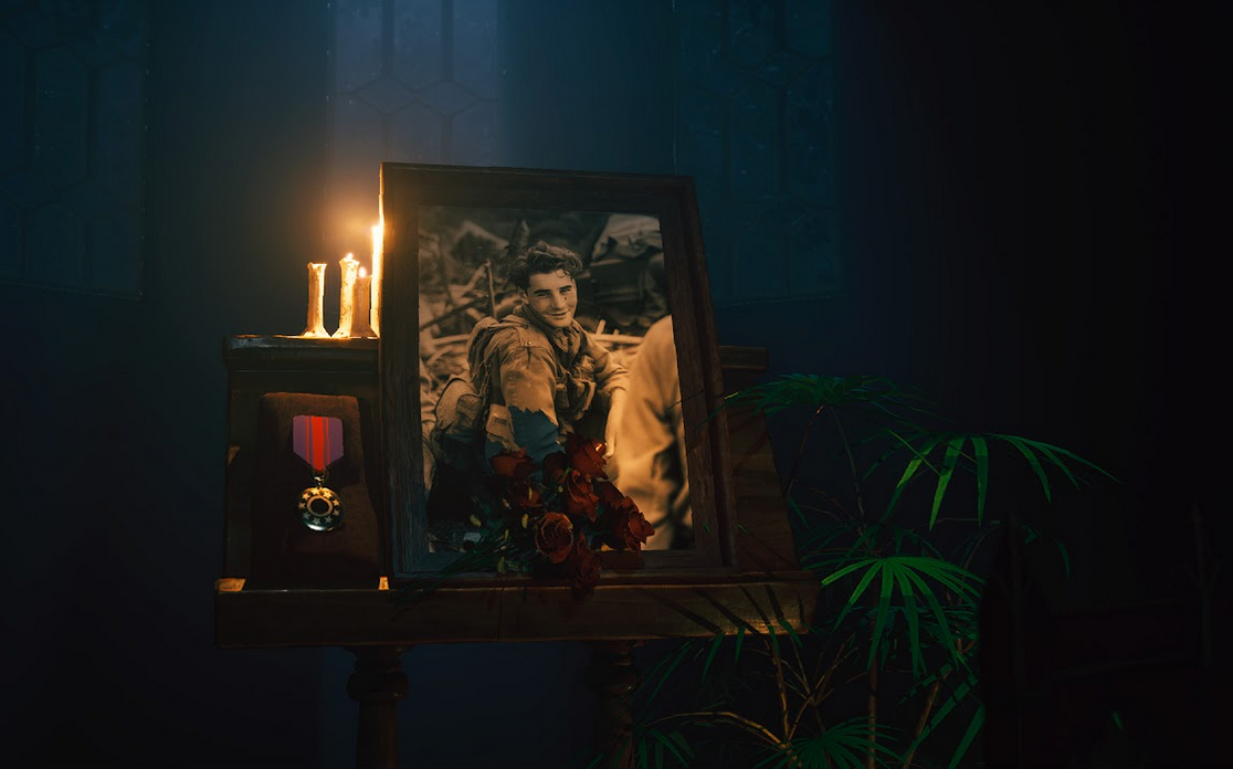 Framed portrait with medals and candles in a dimly lit room