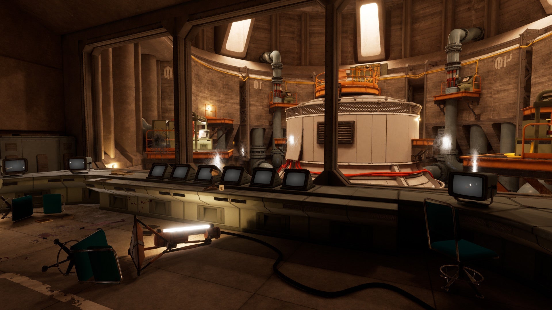 Control room with multiple monitors and industrial equipment in a dimly lit setting