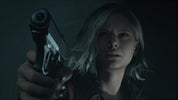 Person holding a gun in a dark setting