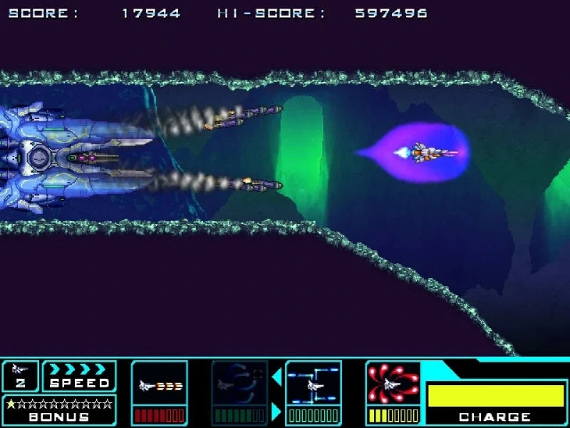 A screenshot from a retro space shooter video game, showing a blue futuristic spaceship firing at a purple enemy ship in a neon-lit tunnel. The top displays a score and high score, and the bottom features a colorful user interface with speed, stars, and charge indicators.
