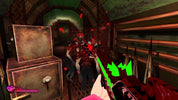 A first-person shooter video game screenshot showing a player holding a red gun with green glowing accents, aiming at two zombie-like enemies in a dark, dilapidated interior hallway. Red blood splatters and a health/pierce indicator are visible on screen.