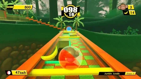 A colorful 3D racing game screenshot showing a spherical orange, red, and green ball racing down a winding track through a jungle-themed environment with banana pieces, scoreboards, and speed information.