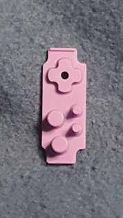 Pink building block piece on a gray surface