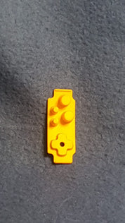 Yellow toy brick on a gray surface