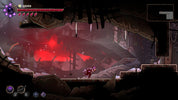 Dark and atmospheric scene from a video game with a character in a dark room with red glowing elements.