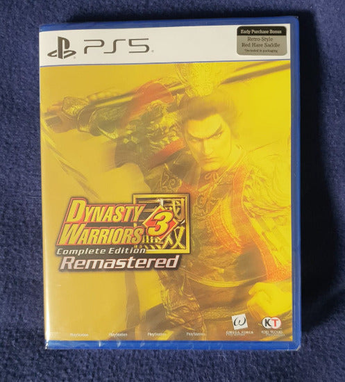 PS5 game case for Dynasty Warriors 3 Remastered, photographed on a textured dark blue fabric background.
